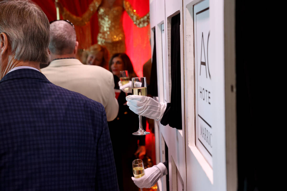 Sparkling wine is offered during the grand opening of the dual-branded AC Hotel by Marriott and ...