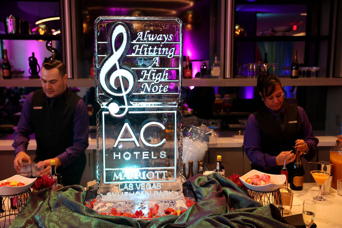 Bartenders prepare drinks during the grand opening of the dual-branded AC Hotel by Marriott and ...