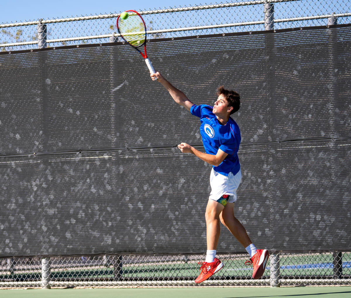Bishop Gorman’s Lucas Rago serves the ball to Palo Verde’s Balin Gupta during the ...