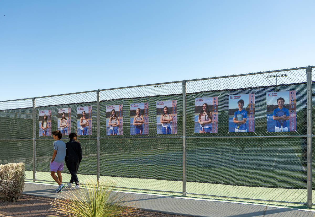 Spectators walk past banners honoring Bishop Gorman seniors during the 5A state doubles and sin ...