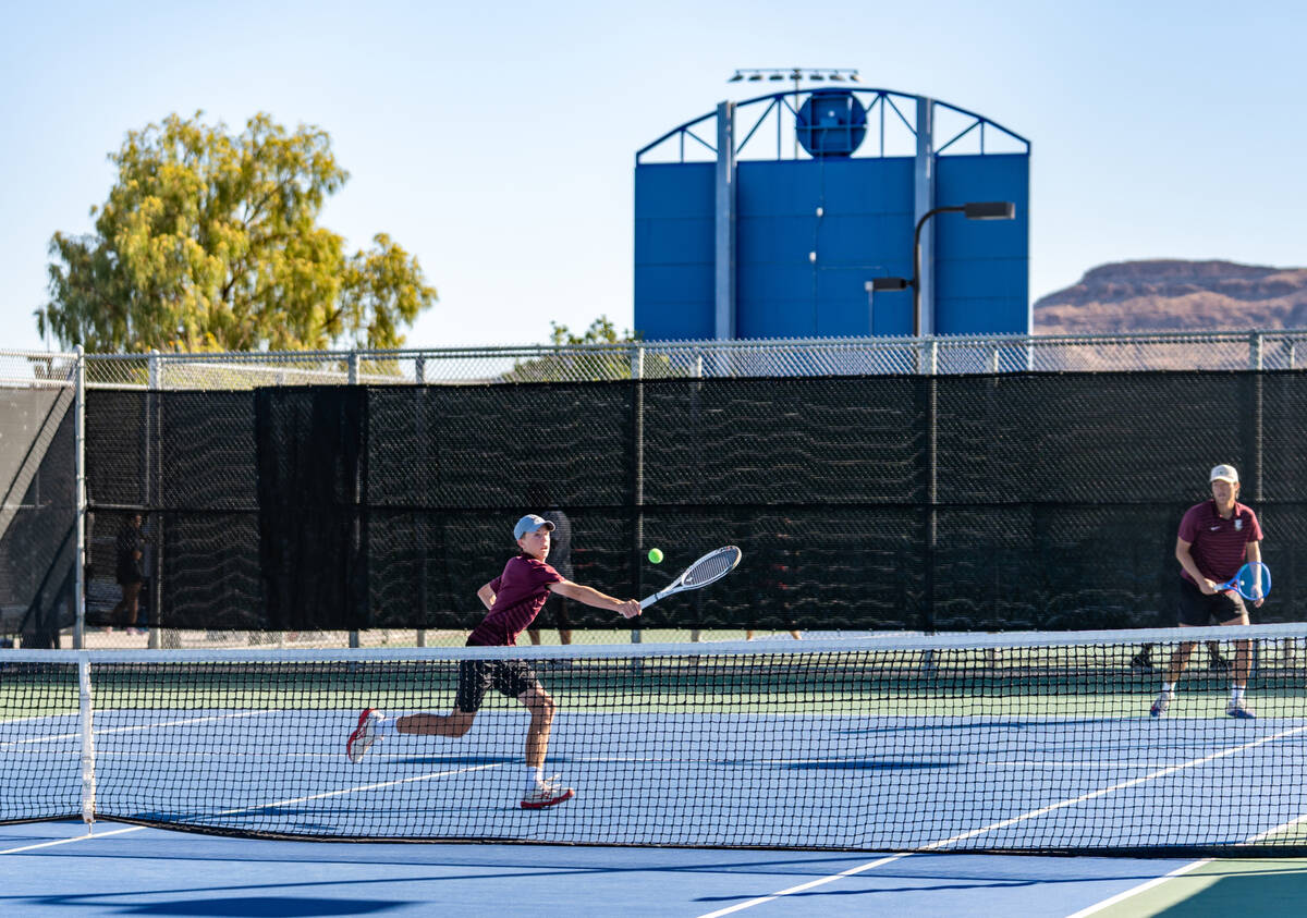 Faith Lutheran’s Huxley Banks dives for the ball alongside partner Alpha Vongxaiburana d ...