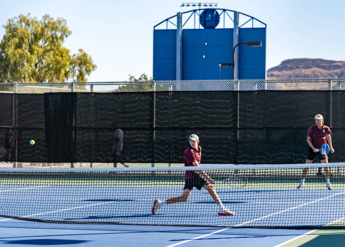 Faith Lutheran’s Huxley Banks returns the ball alongside partner Alpha Vongxaiburana dur ...