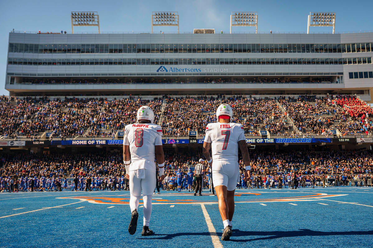 UNLV’s Marsel McDuffie (8) and Cameron Friel (7) walk onto the field during the game aga ...