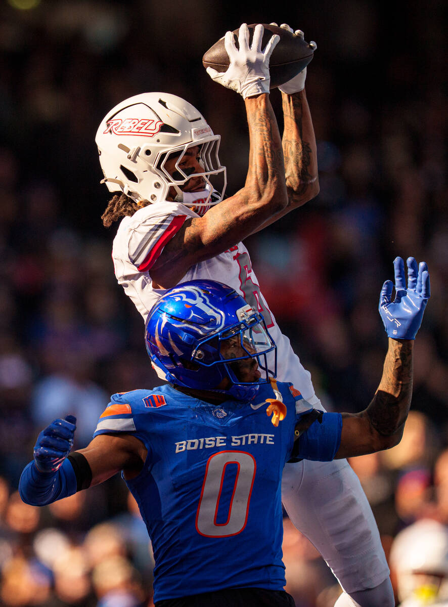 UNLV wide receiver Jaden Bradley (6) catches the ball over Boise State safety Ty Benefield (0) ...