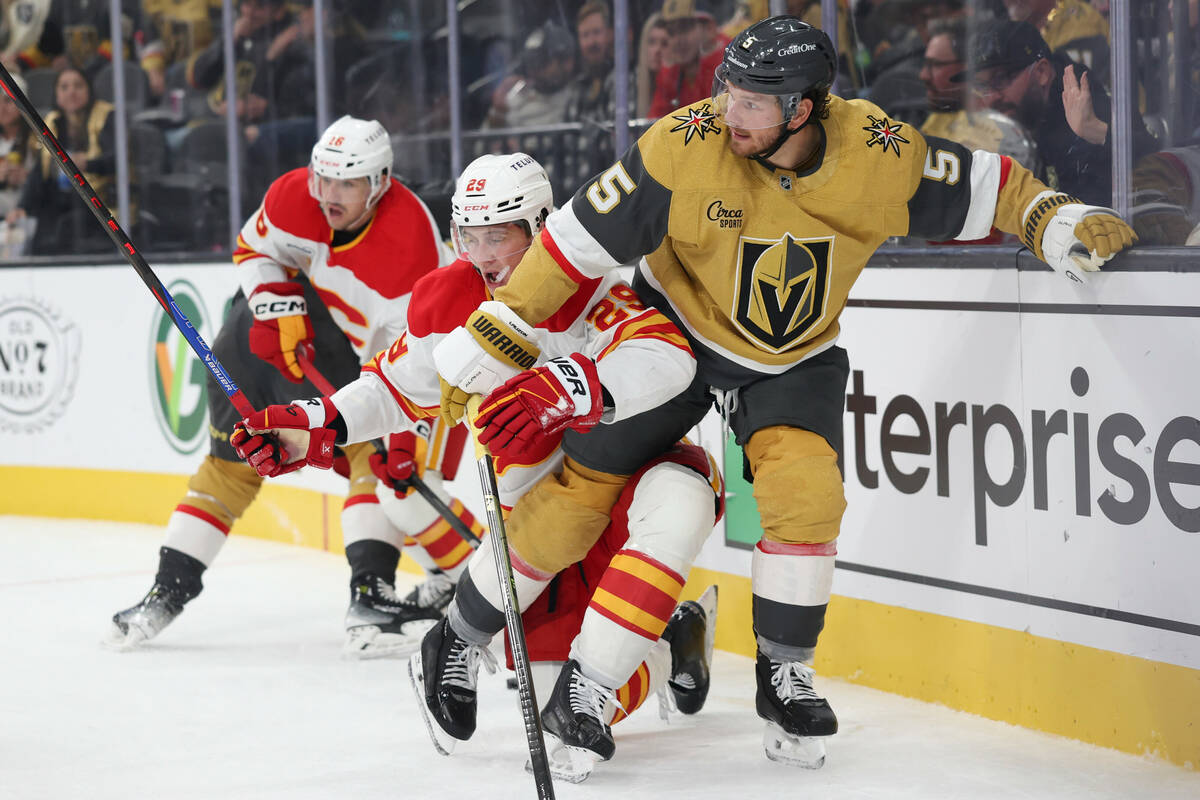 Calgary Flames left wing Samuel Honzek (29) and Vegas Golden Knights defenseman Jeremy Lauzon ( ...
