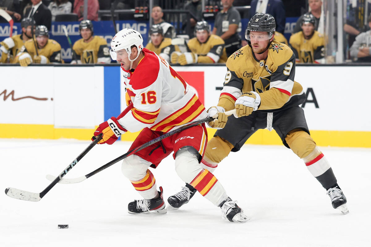 Calgary Flames center Morgan Frost (16) skates against Vegas Golden Knights center Jack Eichel ...