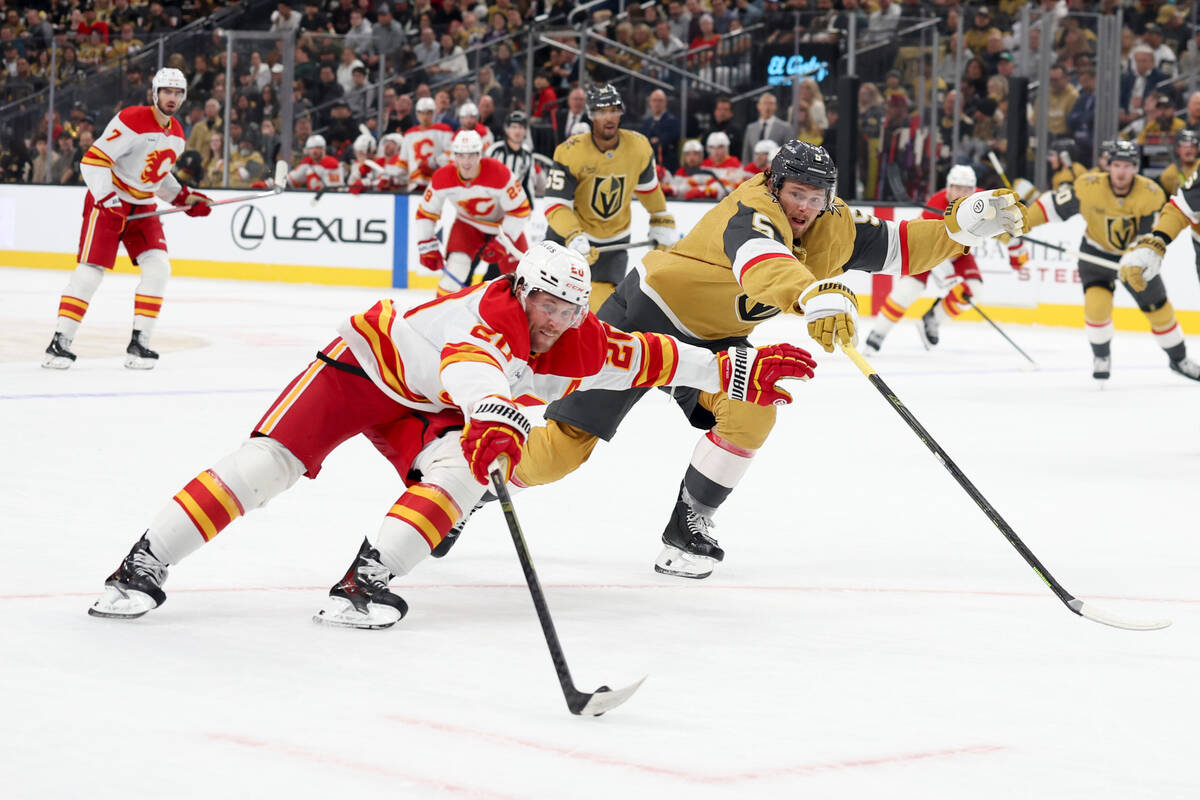 Calgary Flames left wing Blake Coleman (20) and Vegas Golden Knights defenseman Jeremy Lauzon ( ...