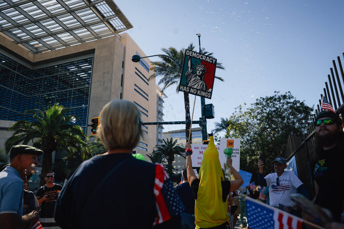 Demonstrators gather for the “No Kings” protest outside the Lloyd D. George U.S. Courthouse ...