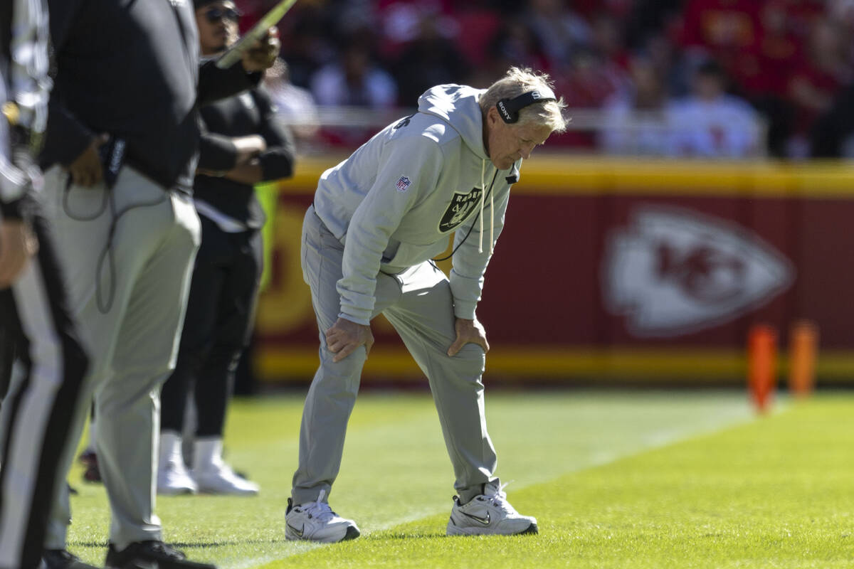 Raiders head coach Pete Carroll bows his head on the sideline during the first half of an NFL g ...