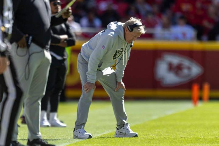 Raiders head coach Pete Carroll bows his head on the sideline during the first half of an NFL g ...