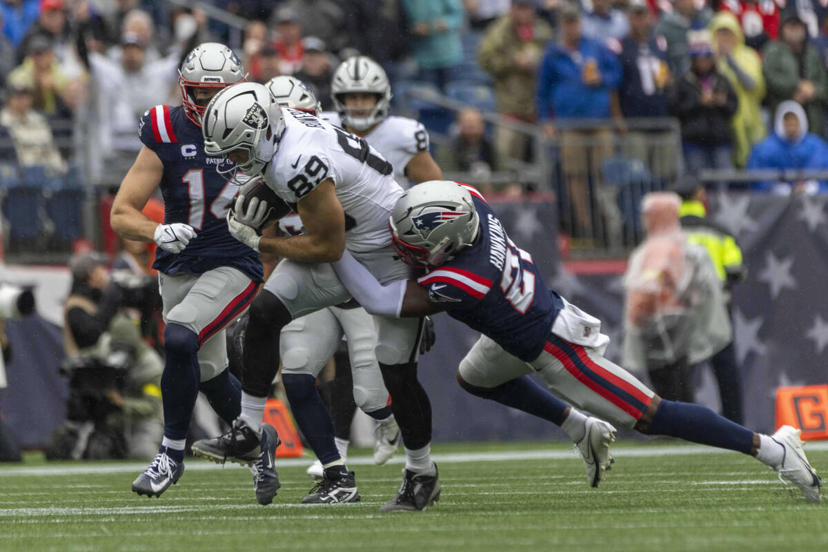 Raiders tight end Brock Bowers (89) makes a catch with New England Patriots linebacker Robert S ...
