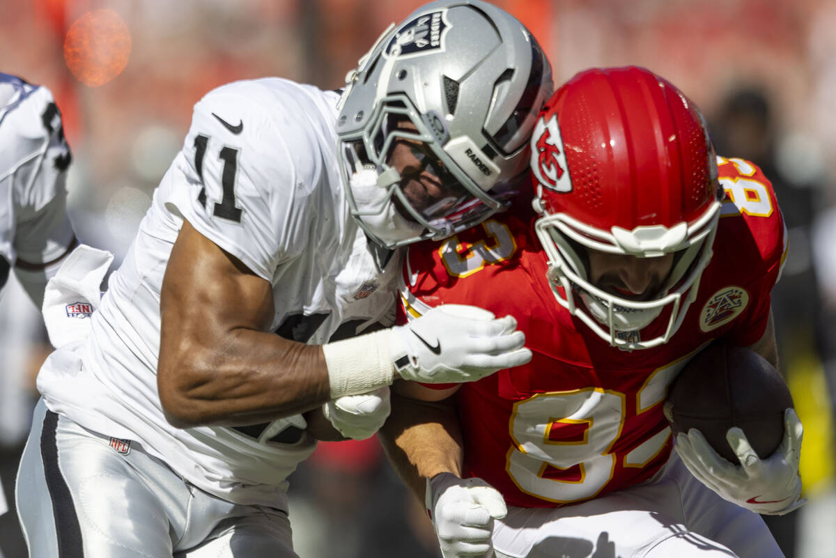 Raiders safety Jeremy Chinn (11) tackles Kansas City Chiefs tight end Noah Gray (83) during the ...
