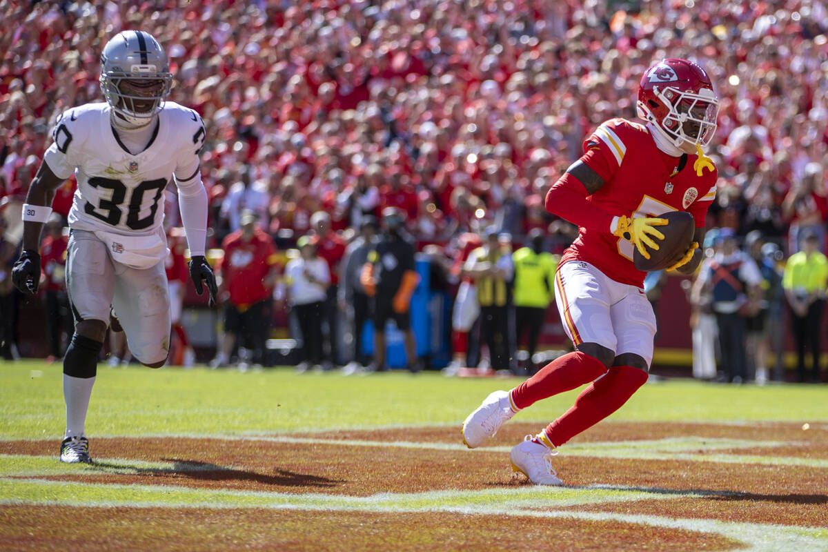 Kansas City Chiefs wide receiver Marquise Brown (5) scores a touchdown with Raiders cornerback ...