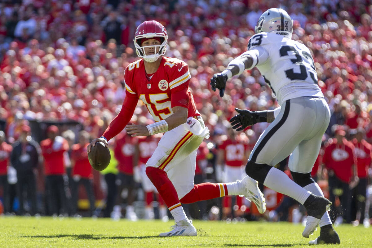 Kansas City Chiefs quarterback Patrick Mahomes (15) looks to pass against Raiders linebacker Ja ...