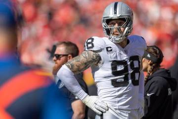 Raiders defensive end Maxx Crosby (98) watches the team play the Kansas City Chiefs from the si ...