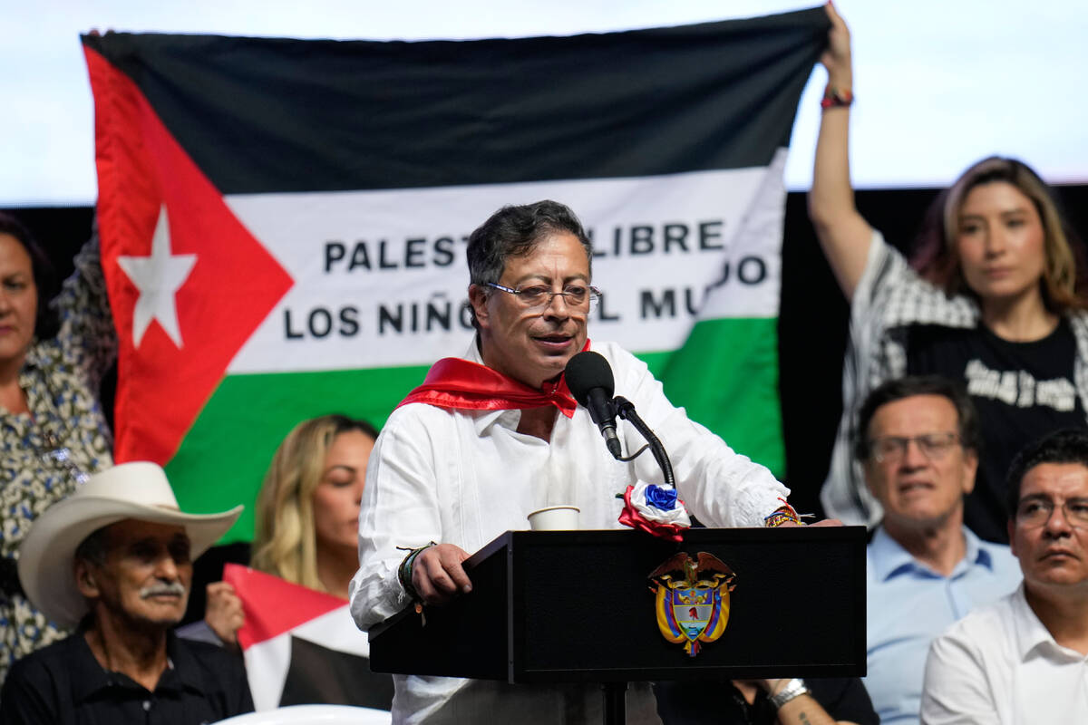 Supporters of Colombian President Gustavo Petro display a Palestinian flag as he addresses a ra ...