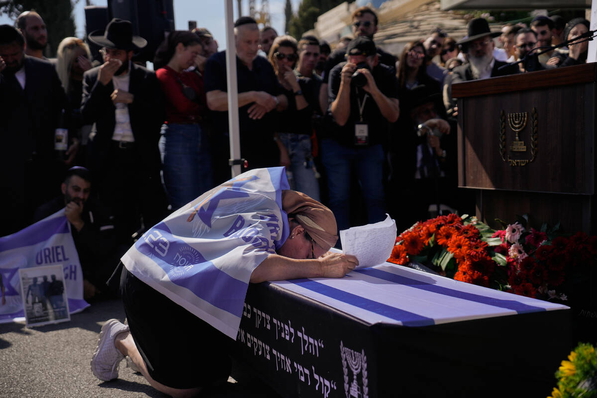 Naomi Baruch grieves over the coffin of her son, Uriel Baruch, a slain hostage whose body was r ...