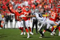 Kansas City Chiefs quarterback Patrick Mahomes (15) throws under pressure from Las Vegas Raider ...