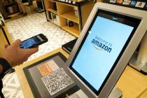 Daniel Thorpe, of Hoboken, N.J., uses the Amazon app to pay for his purchase at the Amazon 4-st ...