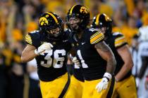 Iowa defensive back Xavier Nwankpa (1) celebrates with teammate Jayden Montgomery (36) after in ...