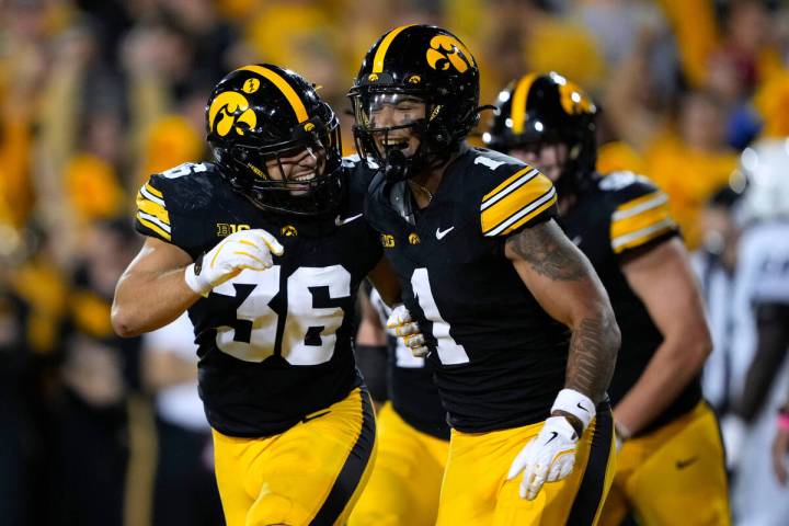 Iowa defensive back Xavier Nwankpa (1) celebrates with teammate Jayden Montgomery (36) after in ...