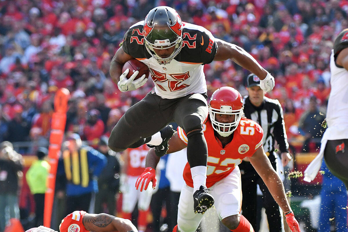Tampa Bay Buccaneers running back Doug Martin leaps over Kansas City Chiefs inside linebacker D ...