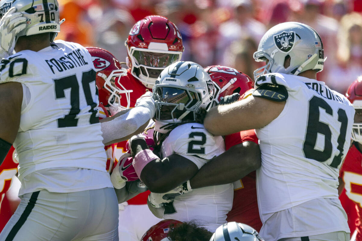 Raiders running back Ashton Jeanty (2) is gang tackled by the Kansas City Chiefs during the fir ...