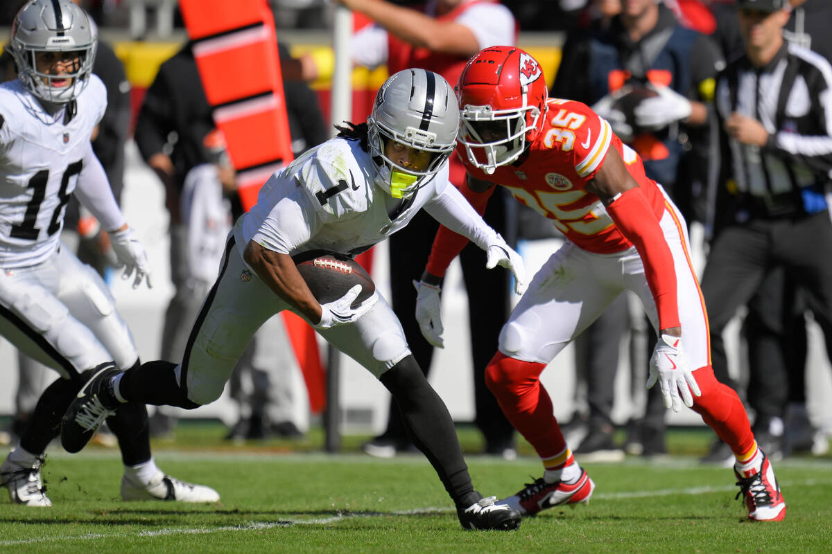 Las Vegas Raiders wide receiver Tre Tucker (1) tries to evade Kansas City Chiefs cornerback Jay ...