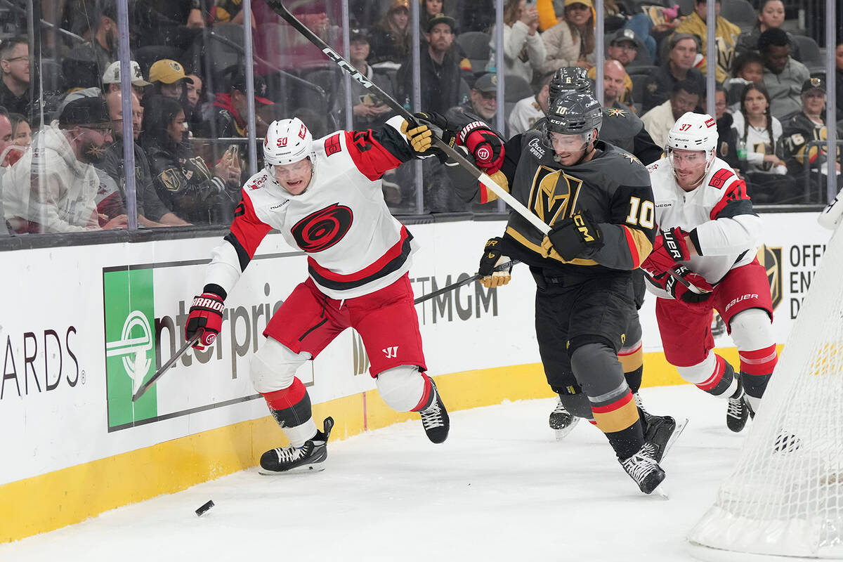 Carolina Hurricanes left wing Eric Robinson (50) and Vegas Golden Knights center Colton Sissons ...