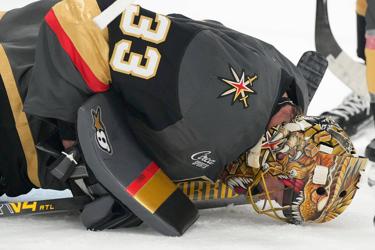 Vegas Golden Knights goaltender Adin Hill lies on the ice after a play against the Carolina Hur ...