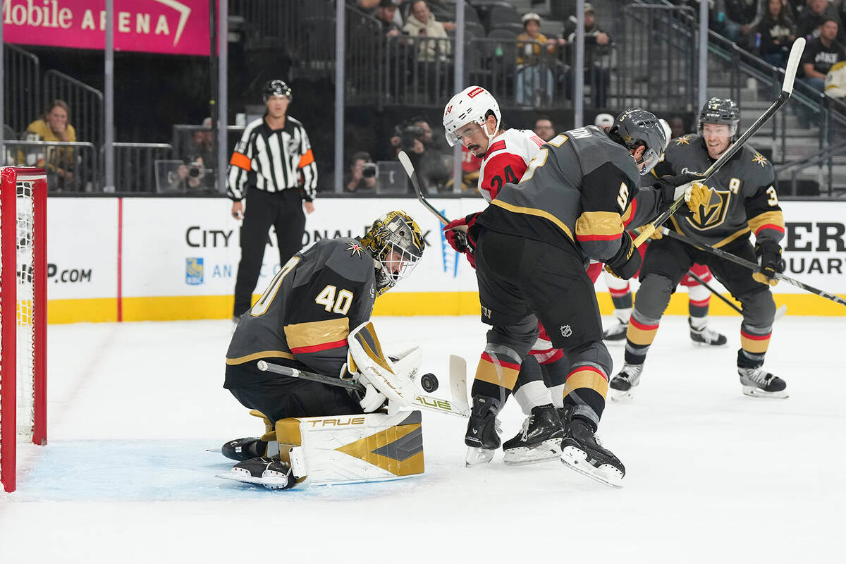 Vegas Golden Knights goaltender Akira Schmid (40) stops a shot by the Carolina Hurricanes durin ...