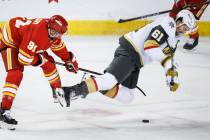 Vegas Golden Knights' Mark Stone, right, is tripped by Calgary Flames' Nazem Kadri du ...