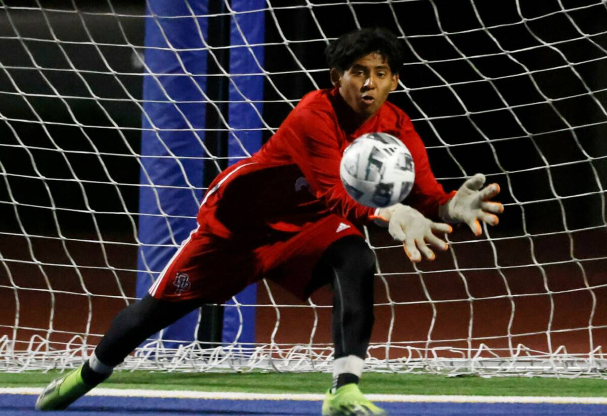 Desert Pines goalkeeper deflects a goal during a high school soccer game against Sunrise Mounta ...