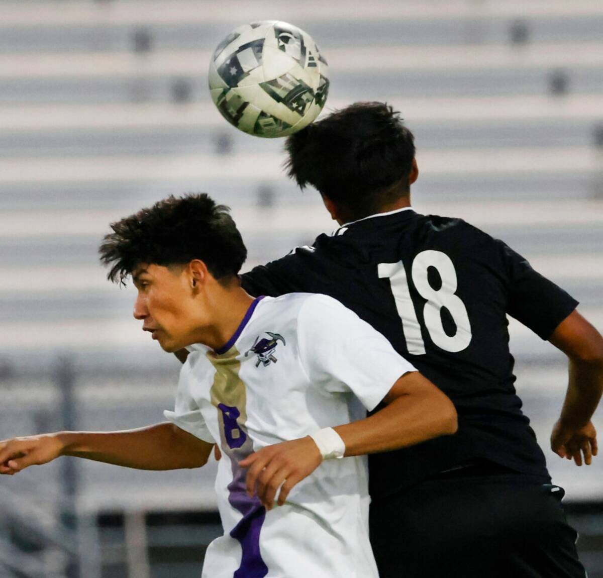 Sunrise Mountain Henry Jimenez (8) and Desert Pines midfielder Johan Tepetzi (18) jump for a he ...