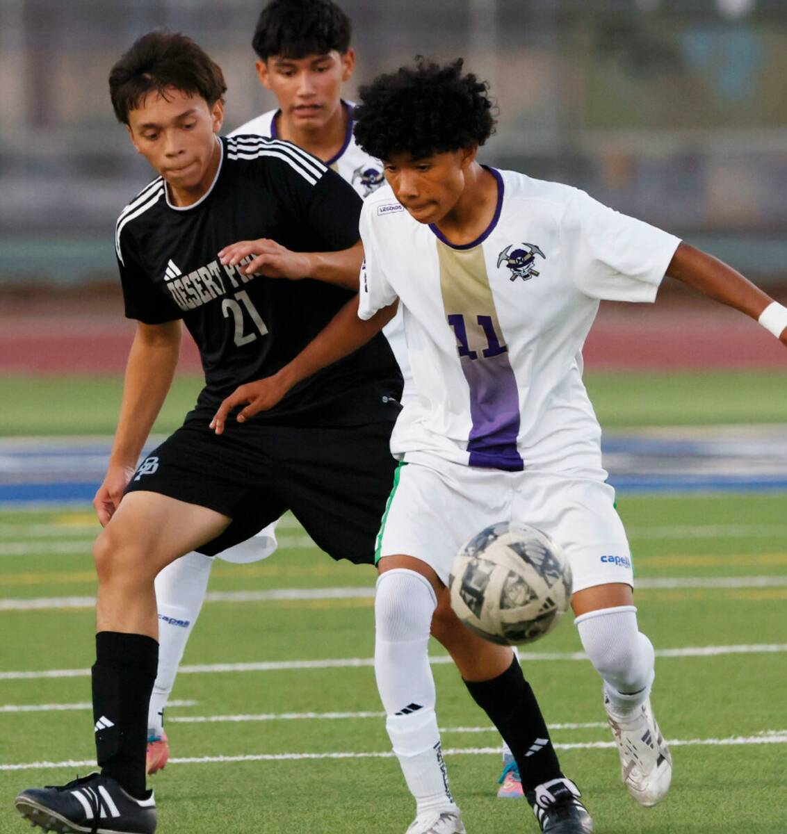 Sunrise Mountain wing Noel Rivera-Ramos (11) protects the ball from Desert Pines midfielder Rau ...