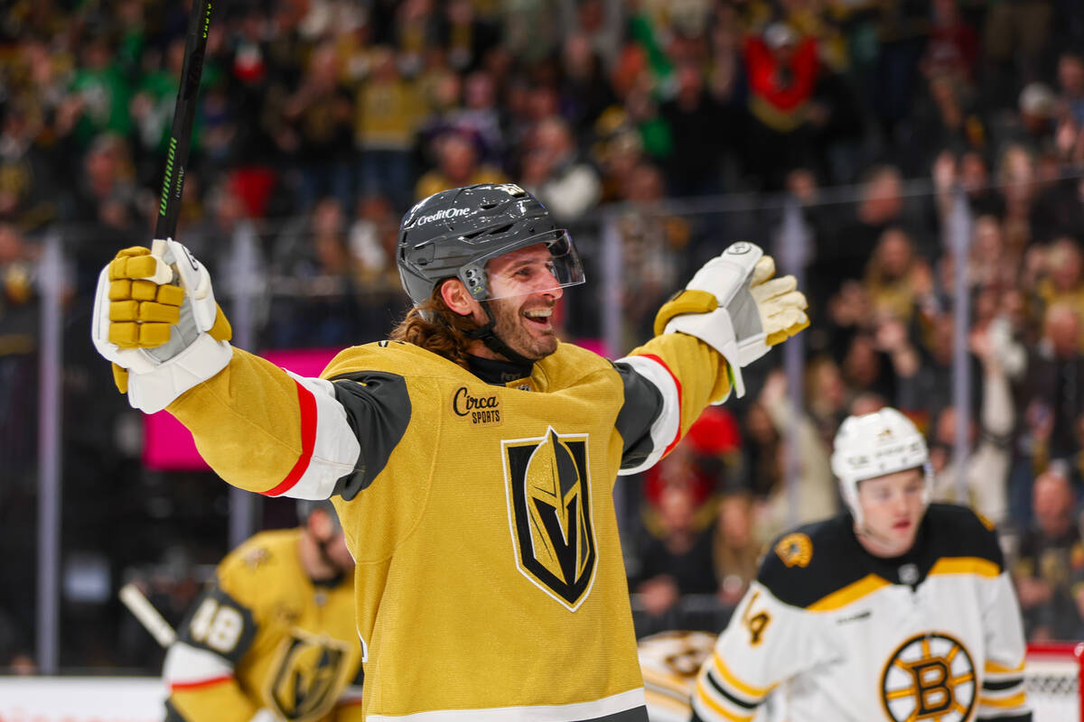 Golden Knights left wing Brandon Saad (20) celebrates teammate Golden Knights left wing Pavel D ...