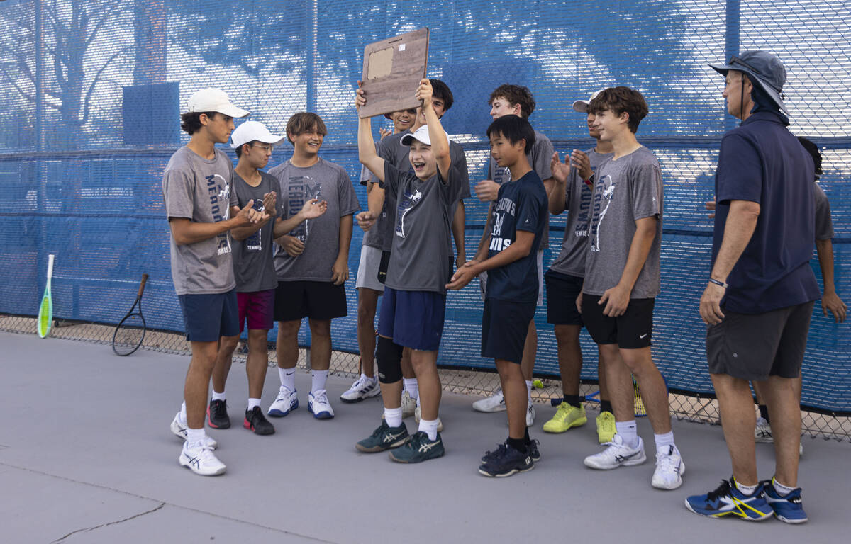 The Meadows’ Levi Schaner lifts the team’s trophy after they won the 4A tennis te ...