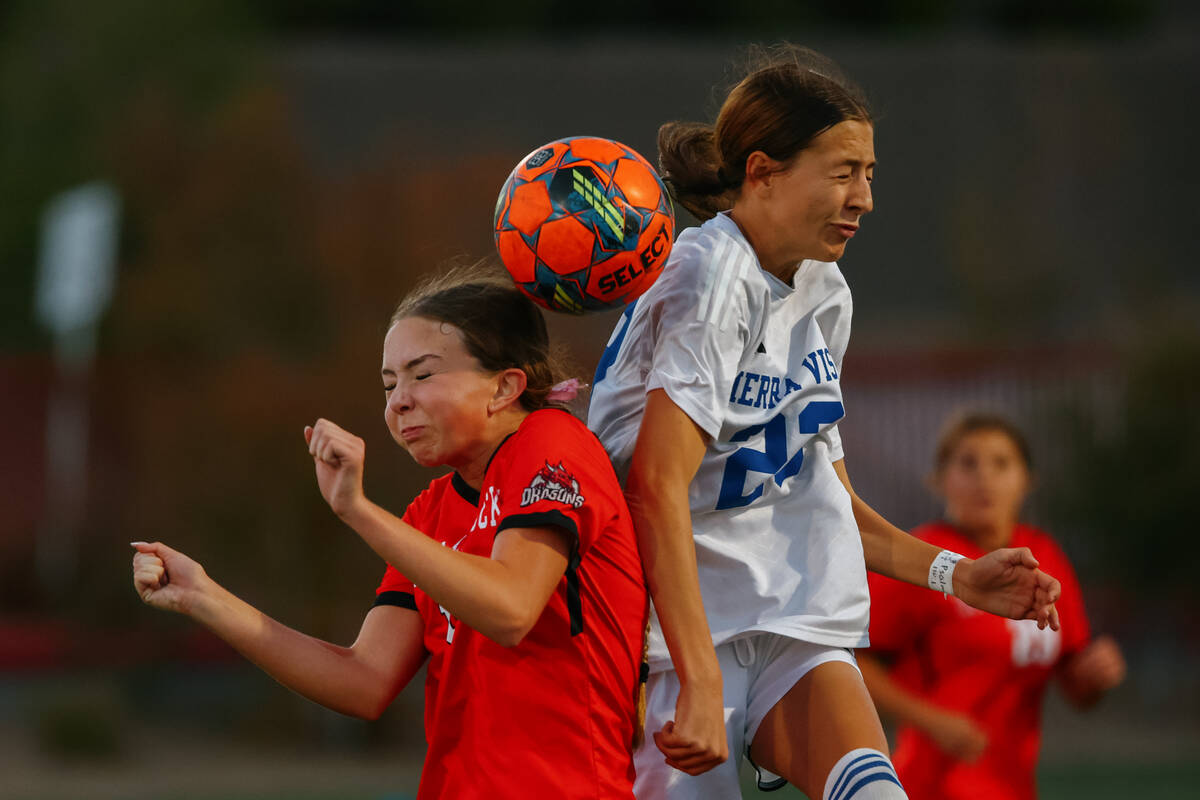 Doral Academy midfielder Chloe Mashore (10) and Sierra Vista midfielder Hunter Hughes (23) jump ...