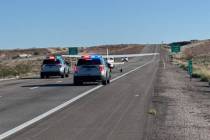 Law enforcement officials respond to an emergency plane landing on Interstate 15 near Mesquite ...