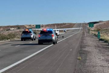 Law enforcement officials respond to an emergency plane landing on Interstate 15 near Mesquite ...