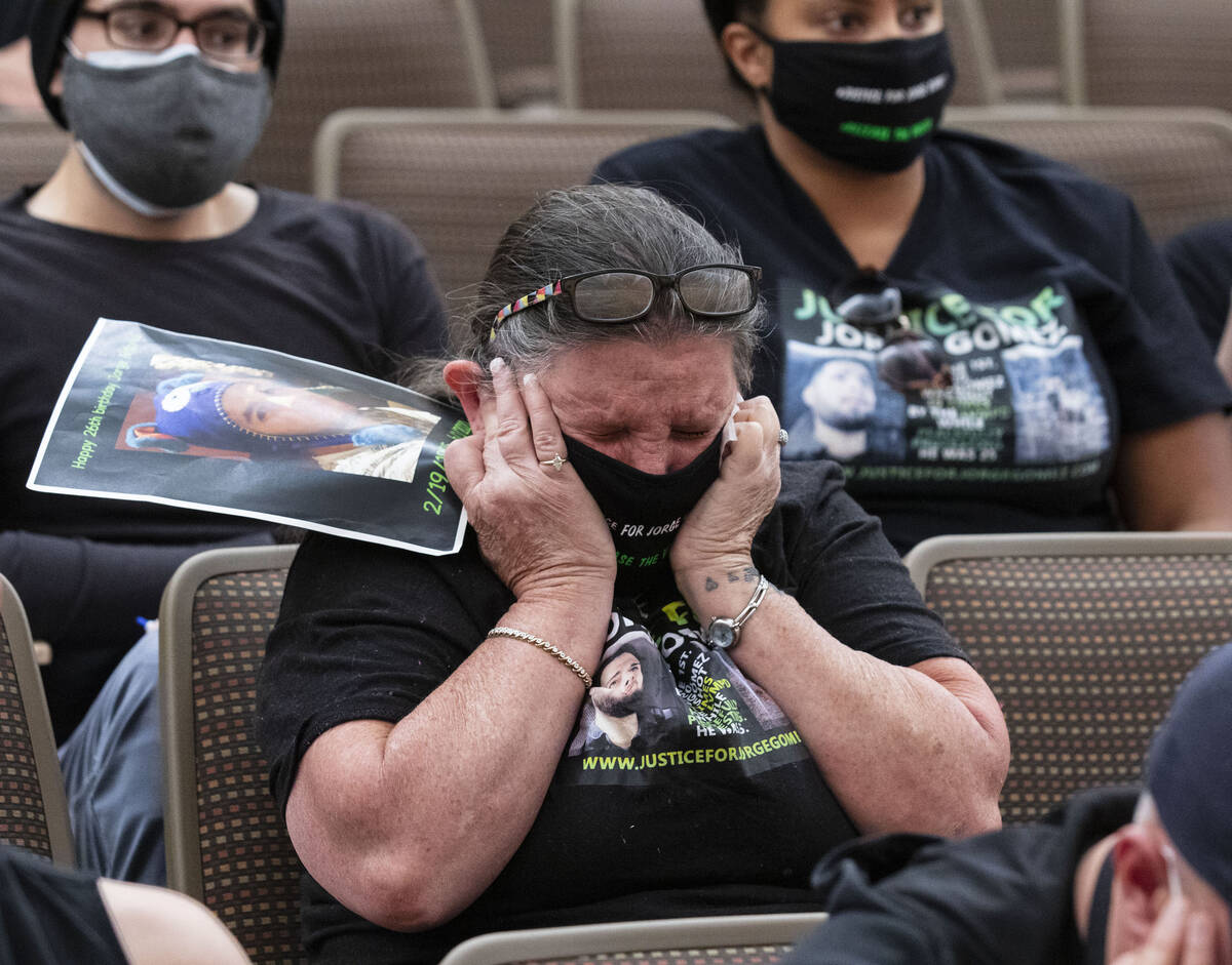 Police accountability activist Carol Luke plugs her ears as video evidence in the fatal police ...