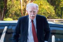 Former Trump administration national security adviser John Bolton, left, arrives for his arraig ...