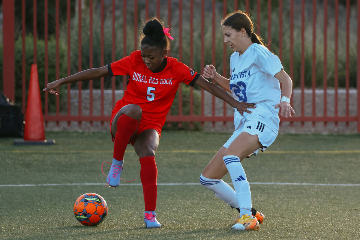 Doral Academy forward Sanyi Thompson (5) tries to dribble around Sierra Vista defender Hunter H ...