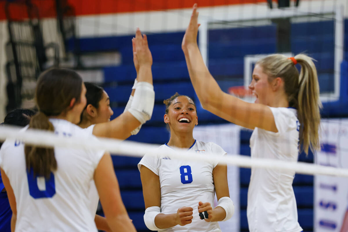 Bishop Gorman outside hitter Ayanna Watson (8), center, celebrates a kill by teammate Ellie Pri ...