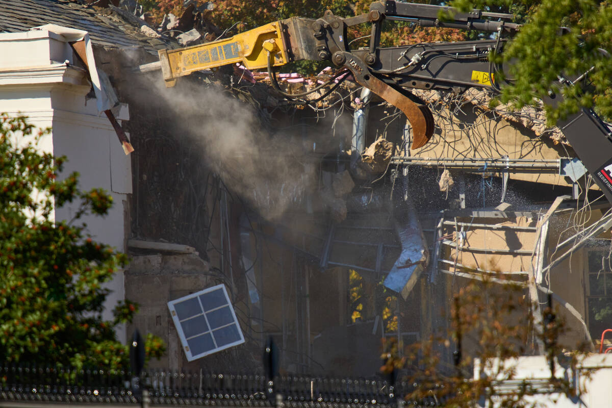 A window dangles from the East Wing as work continues on the demolition of a part of the East W ...
