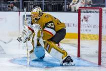 Golden Knights goaltender Adin Hill (33) is showered in ice as he defends the net against the U ...