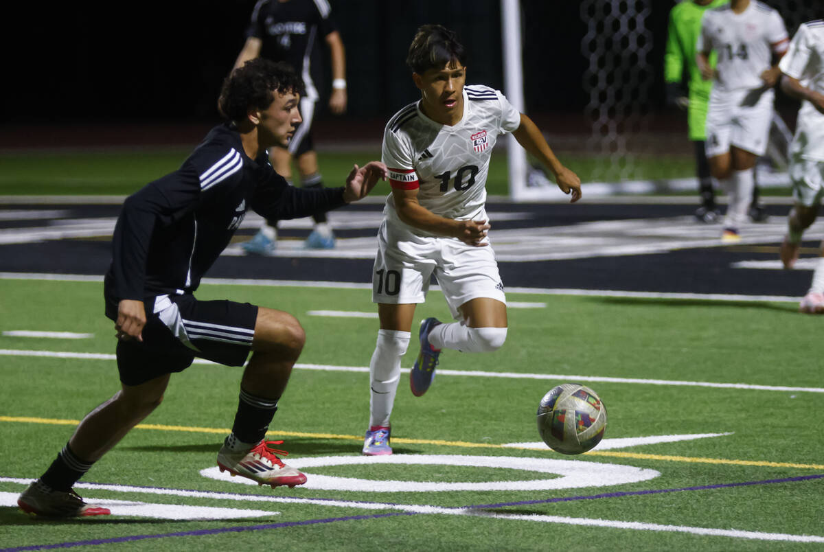 Las Vegas' Anthony Cardenas (10) runs with the ball as Palo Verde's Mason Feeley defe ...