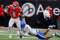 Air Force Falcons defensive back Korey Johnson (2) attempts to trip UNLV running back Jai' ...