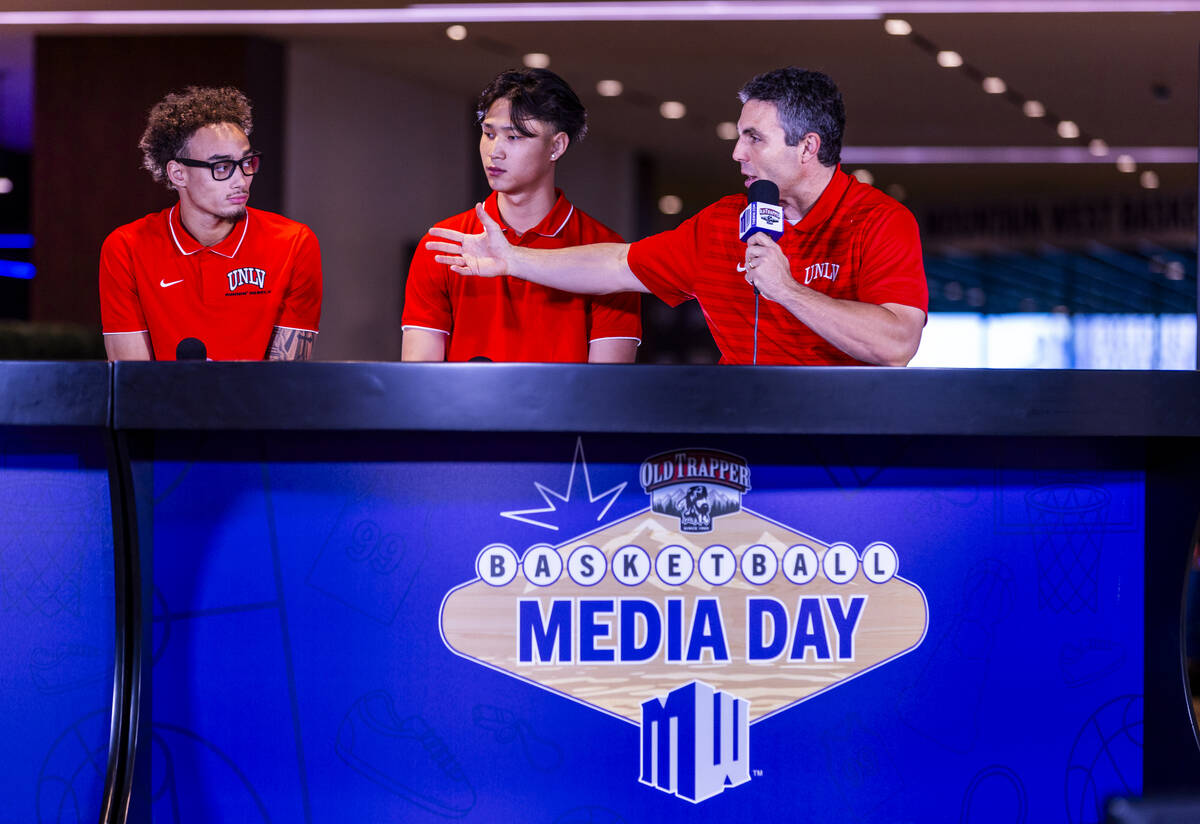 (From right) UNLV head coach Josh Pastner answers a question joined by players Myles Che and Dr ...
