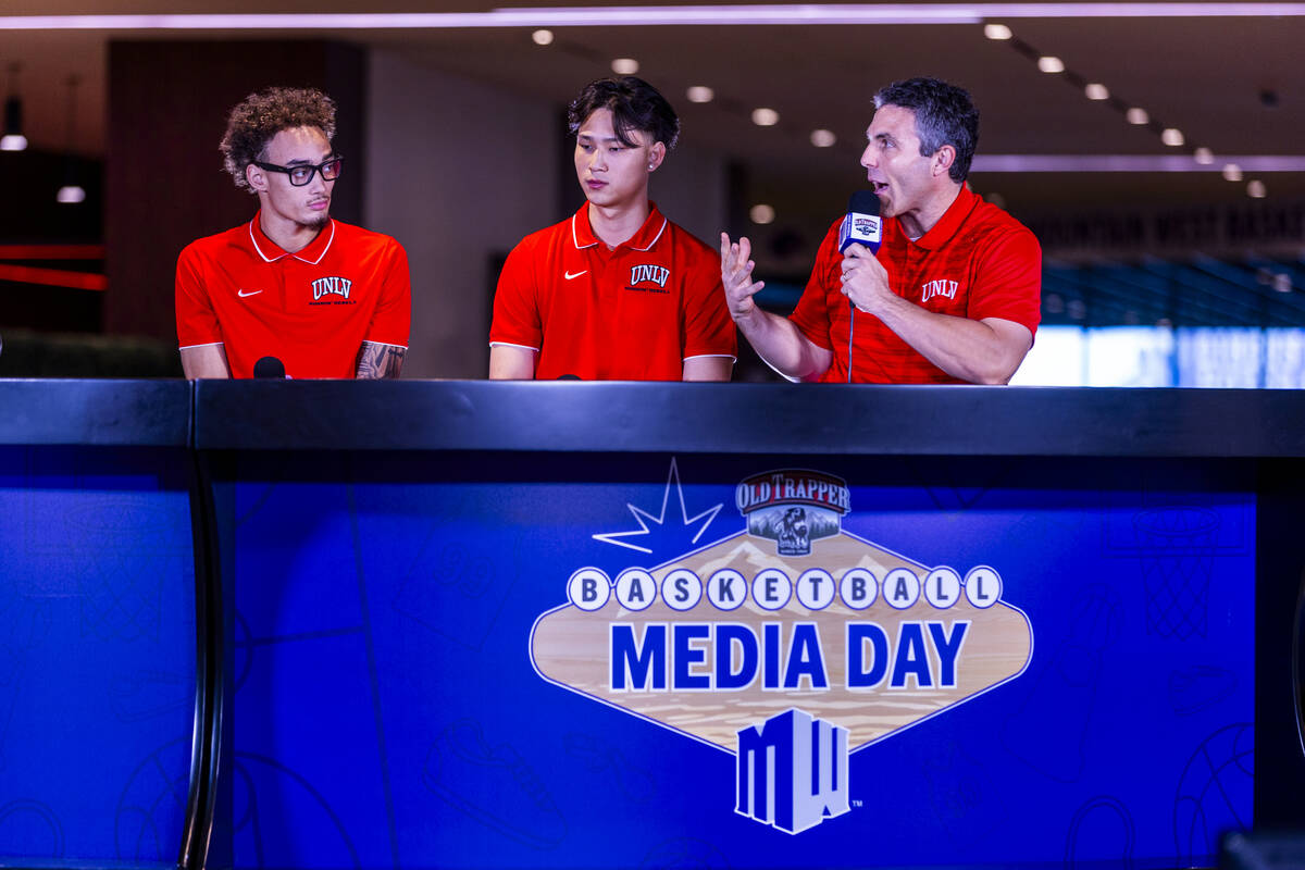 (From right) UNLV head coach Josh Pastner answers a question joined by players Myles Che and Dr ...